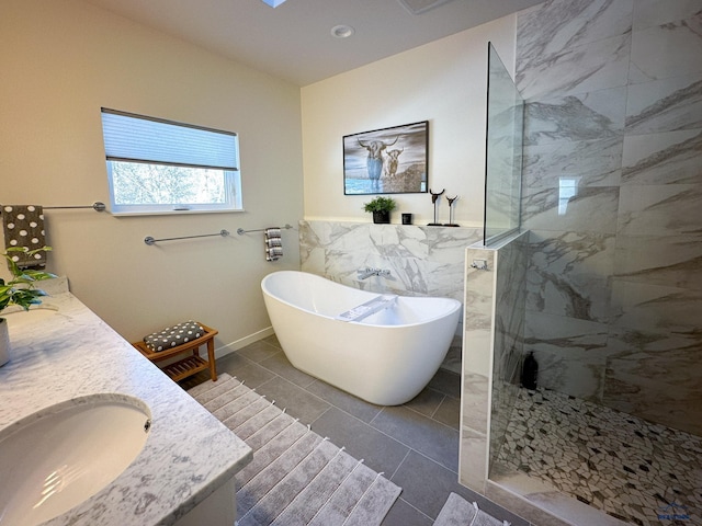 20216 Ponderosa Dr, Whitewood, SD 57793 - bathroom with a freestanding bath, a walk in shower, double vanity, tile walls, and tile patterned floors