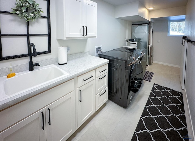 20216 Ponderosa Dr, Whitewood, SD 57793 - washroom with cabinet space, washer and clothes dryer, light floors, and baseboards