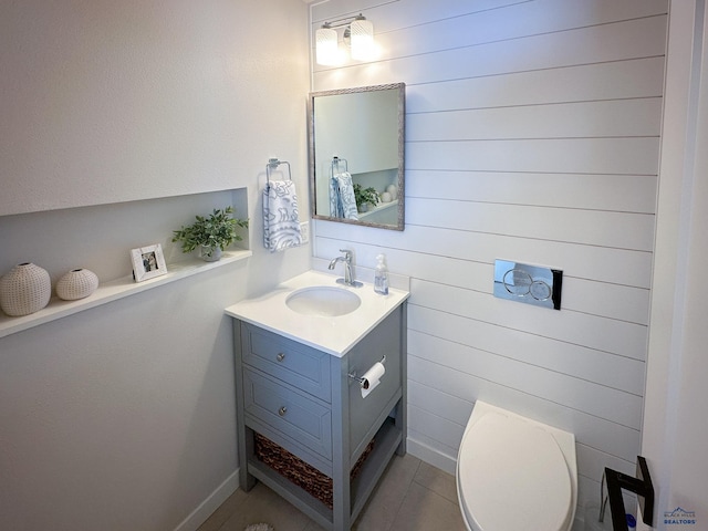 20216 Ponderosa Dr, Whitewood, SD 57793 - half bath with vanity, wooden walls, tile patterned flooring, toilet, and baseboards