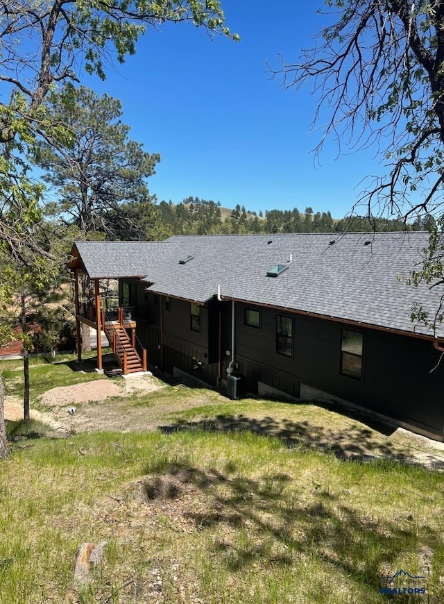 20216 Ponderosa Dr, Whitewood, SD 57793 - back of house with roof with shingles, stairs, and central AC unit