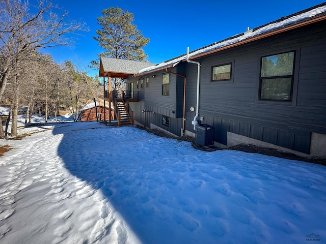 20216 Ponderosa Dr, Whitewood, SD 57793 - snow covered back of property featuring stairs and cooling unit