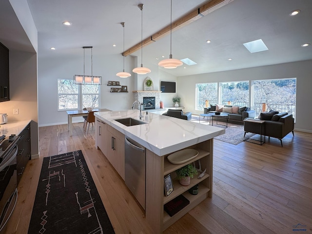 20216 Ponderosa Dr, Whitewood, SD 57793 - kitchen featuring a sink, a skylight, open shelves, dishwasher, and a fireplace