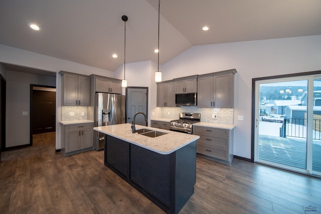 kitchen with lofted ceiling, stainless steel appliances, gray cabinets, and a sink