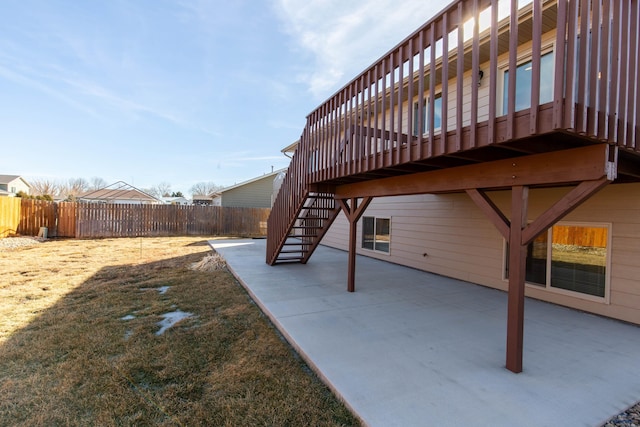 view of yard with stairs, a patio area, fence, and a wooden deck