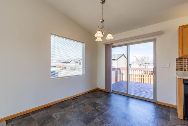 unfurnished dining area with lofted ceiling, baseboards, and an inviting chandelier