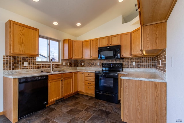 kitchen with vaulted ceiling, black appliances, backsplash, and a sink