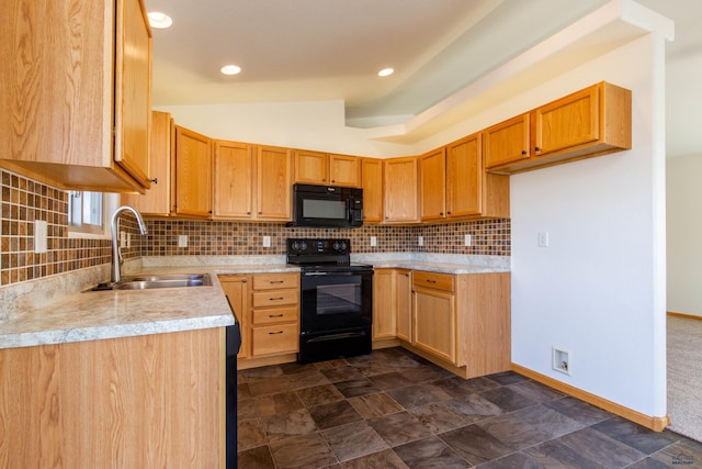 kitchen featuring light countertops, backsplash, vaulted ceiling, a sink, and black appliances