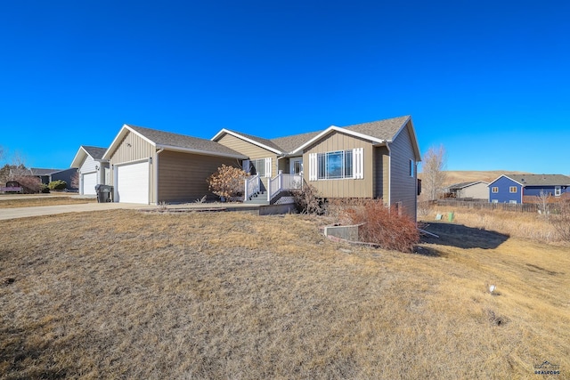 ranch-style home featuring board and batten siding, an attached garage, and a residential view