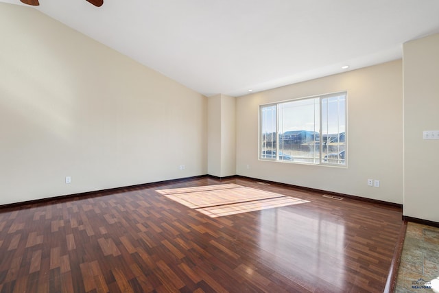 unfurnished room with visible vents, baseboards, and wood finished floors