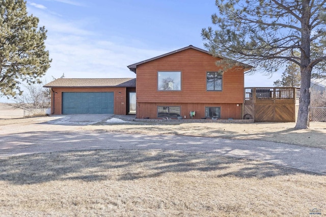 split level home with driveway and an attached garage