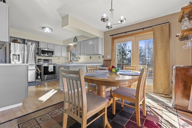 dining area with an inviting chandelier and wood finished floors