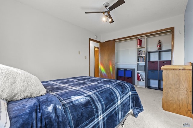 bedroom with light carpet, a closet, and a ceiling fan