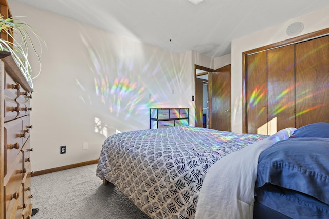 bedroom featuring a closet, carpet flooring, and baseboards