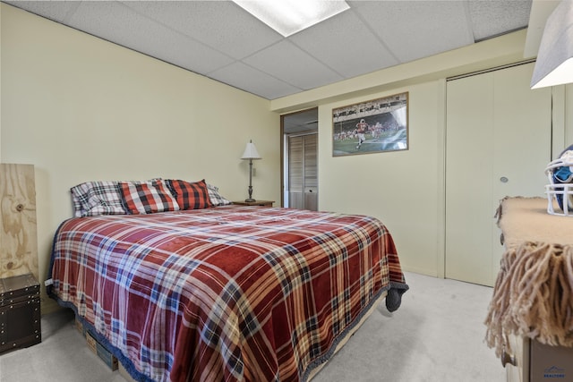 carpeted bedroom featuring a paneled ceiling