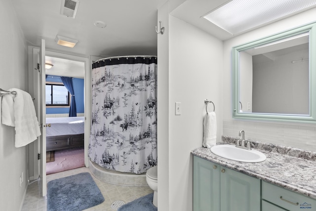 bathroom featuring toilet, visible vents, a shower with shower curtain, and vanity