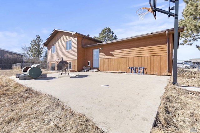 back of property featuring fence