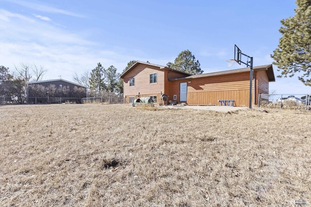 back of house featuring fence