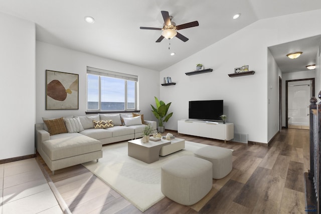 living area featuring vaulted ceiling, baseboards, wood finished floors, and recessed lighting