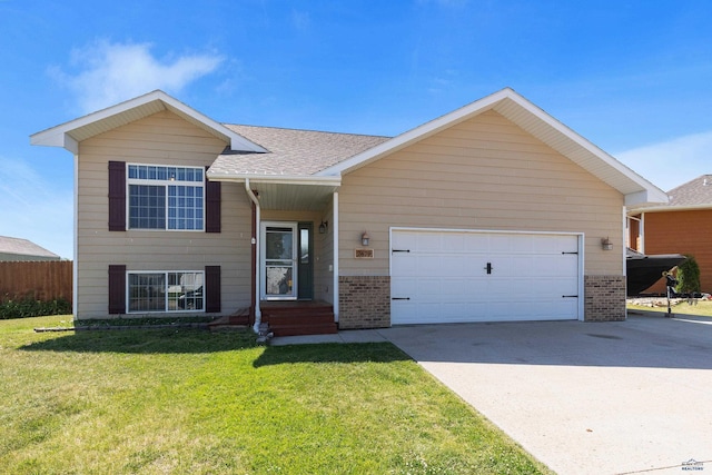 tri-level home featuring a garage, concrete driveway, roof with shingles, a front yard, and brick siding