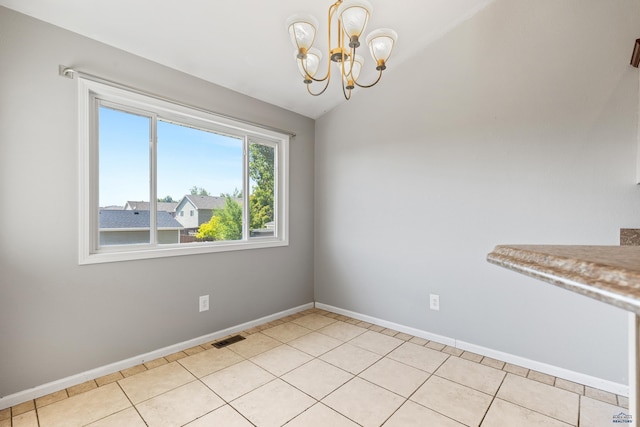 unfurnished dining area with light tile patterned floors, lofted ceiling, a notable chandelier, visible vents, and baseboards