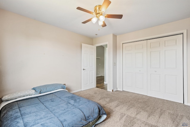 carpeted bedroom with a closet, baseboards, and a ceiling fan