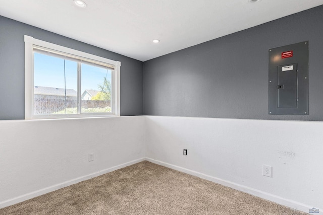 carpeted empty room with electric panel, baseboards, and recessed lighting