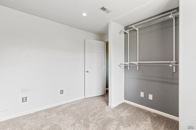 unfurnished bedroom with baseboards, visible vents, carpet flooring, and recessed lighting