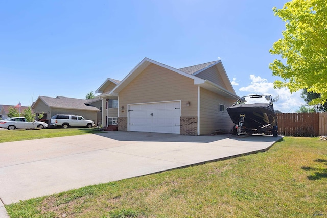 view of home's exterior with brick siding, a lawn, fence, a garage, and driveway