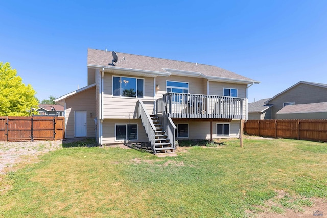 back of property featuring a fenced backyard, a yard, a deck, and stairs