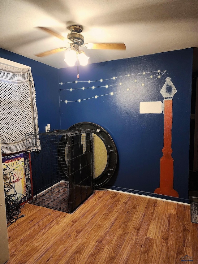 bedroom featuring ceiling fan and wood finished floors