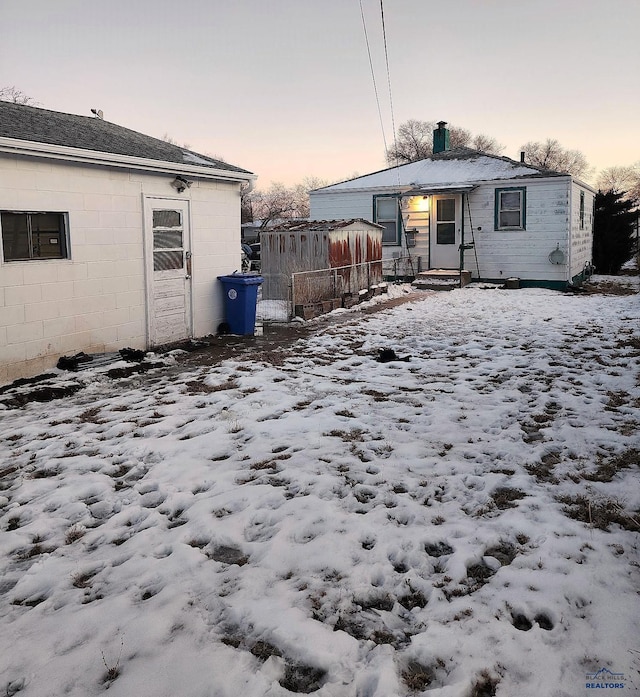 snow covered property featuring concrete block siding