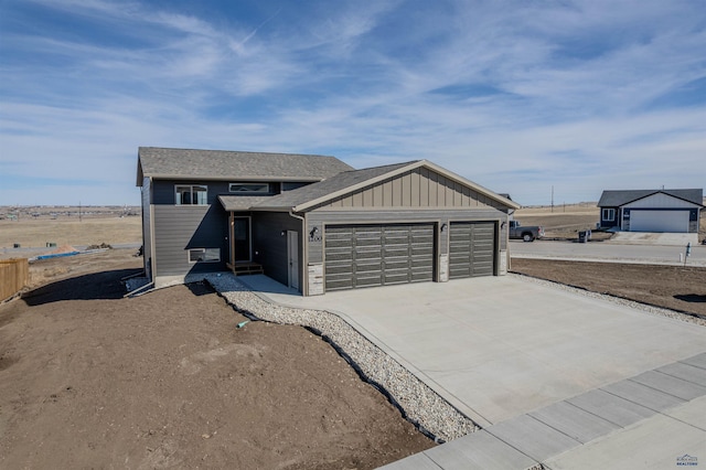 view of front of home featuring driveway, board and batten siding, and an attached garage