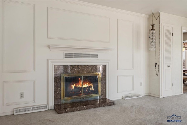 room details featuring ornamental molding, carpet flooring, visible vents, and a high end fireplace