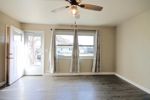 empty room featuring plenty of natural light, baseboards, and wood finished floors