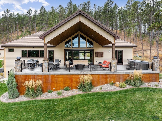 back of house featuring a patio, a lawn, an outdoor living space, and a tiled roof