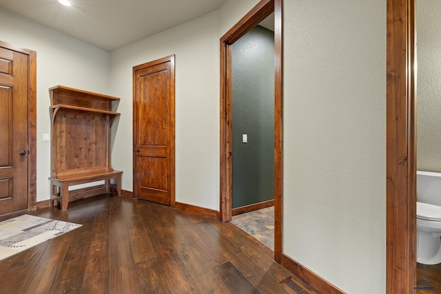 mudroom featuring hardwood / wood-style flooring, visible vents, and baseboards