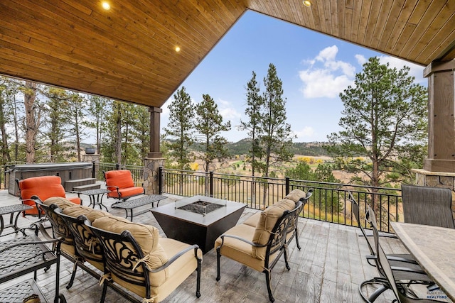 view of patio / terrace featuring an outdoor living space with a fire pit and a hot tub