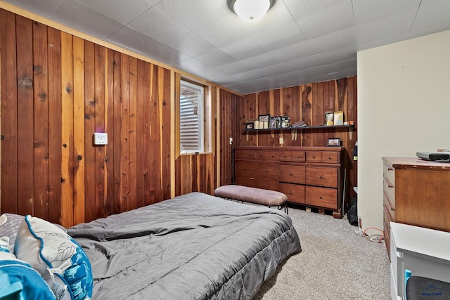 bedroom featuring wood walls and carpet flooring