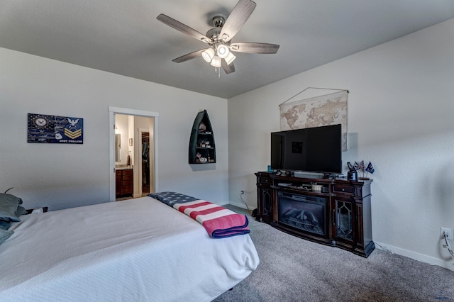 carpeted bedroom featuring connected bathroom, a ceiling fan, and baseboards