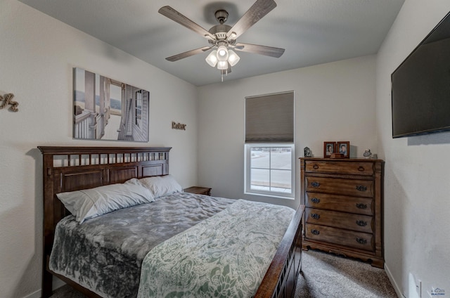 carpeted bedroom featuring ceiling fan and baseboards