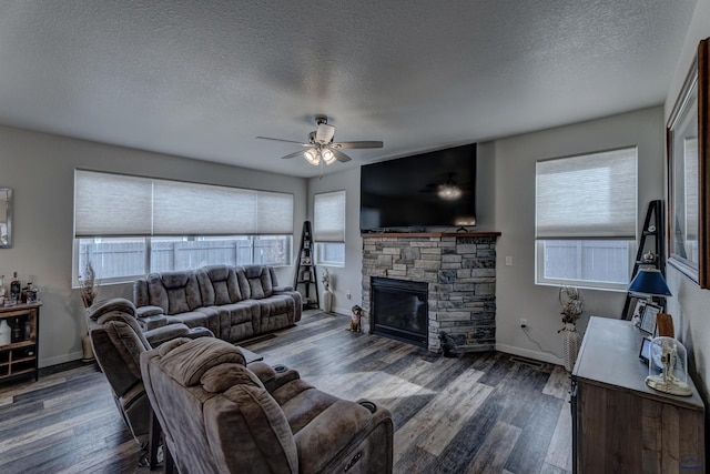 living room with a healthy amount of sunlight, a fireplace, baseboards, and wood finished floors