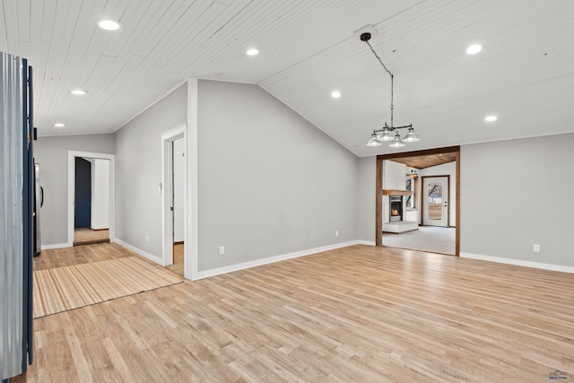 unfurnished living room featuring lofted ceiling, recessed lighting, light wood-style floors, wooden ceiling, and a lit fireplace