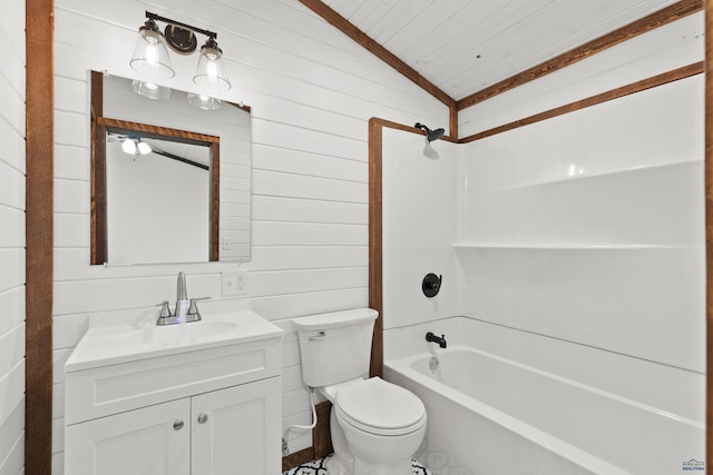 bathroom with wooden walls, toilet, vaulted ceiling, vanity, and washtub / shower combination