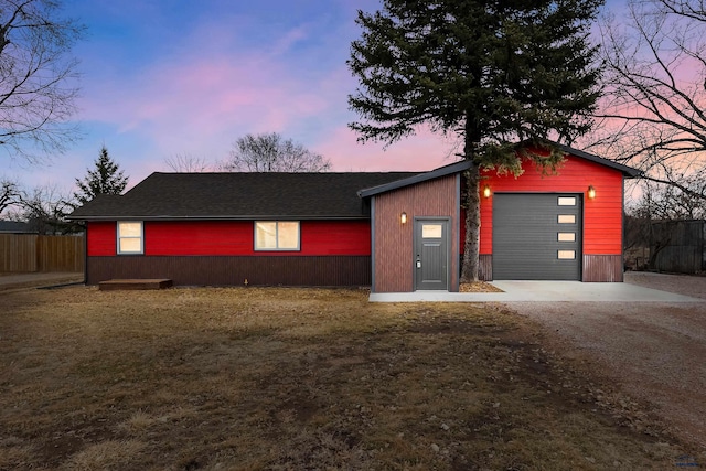 exterior space featuring driveway, a yard, fence, and an outdoor structure