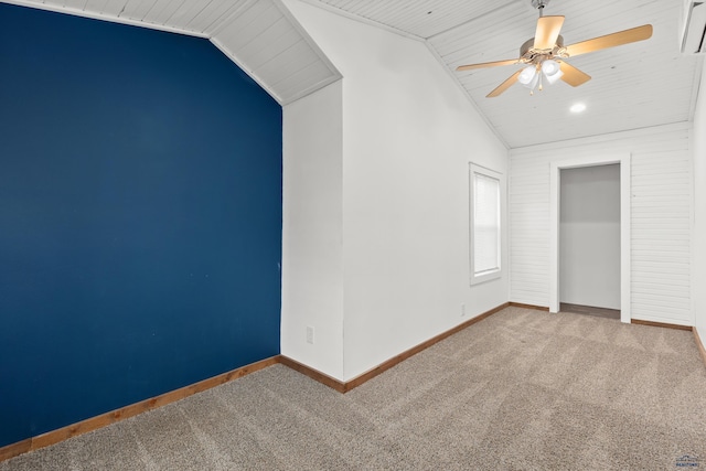 unfurnished bedroom with lofted ceiling, ceiling fan, carpet, and baseboards