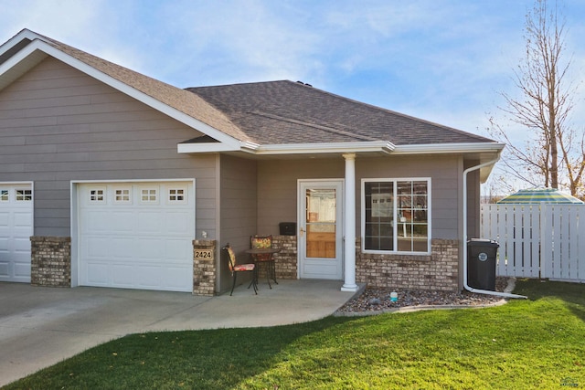 view of front of house with a garage, a shingled roof, fence, driveway, and a front lawn