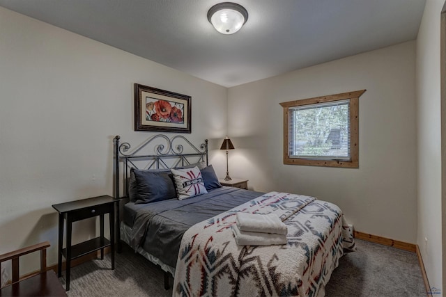 bedroom with carpet flooring and baseboards