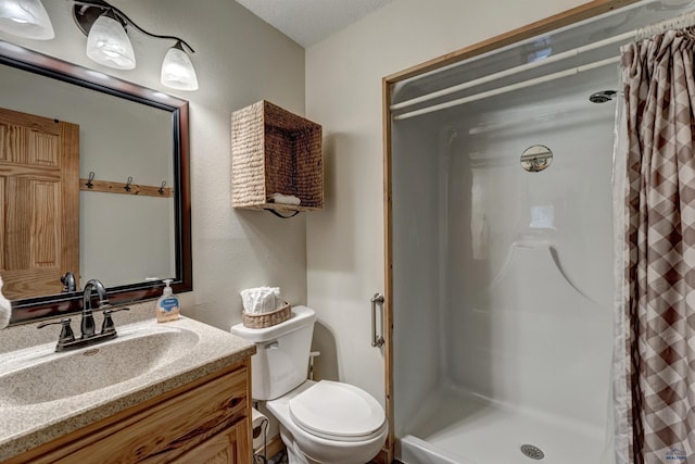 full bath with a shower stall, toilet, and vanity