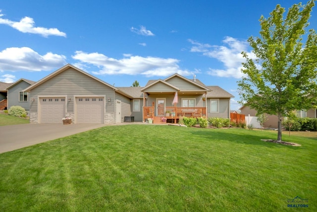 ranch-style house featuring an attached garage, fence, driveway, stone siding, and a front yard