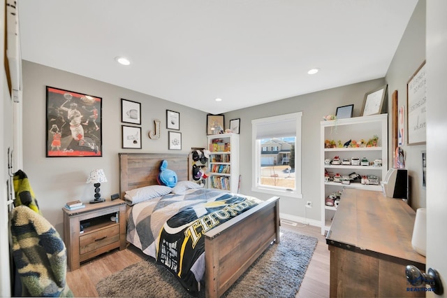 bedroom with baseboards, recessed lighting, and light wood-style floors